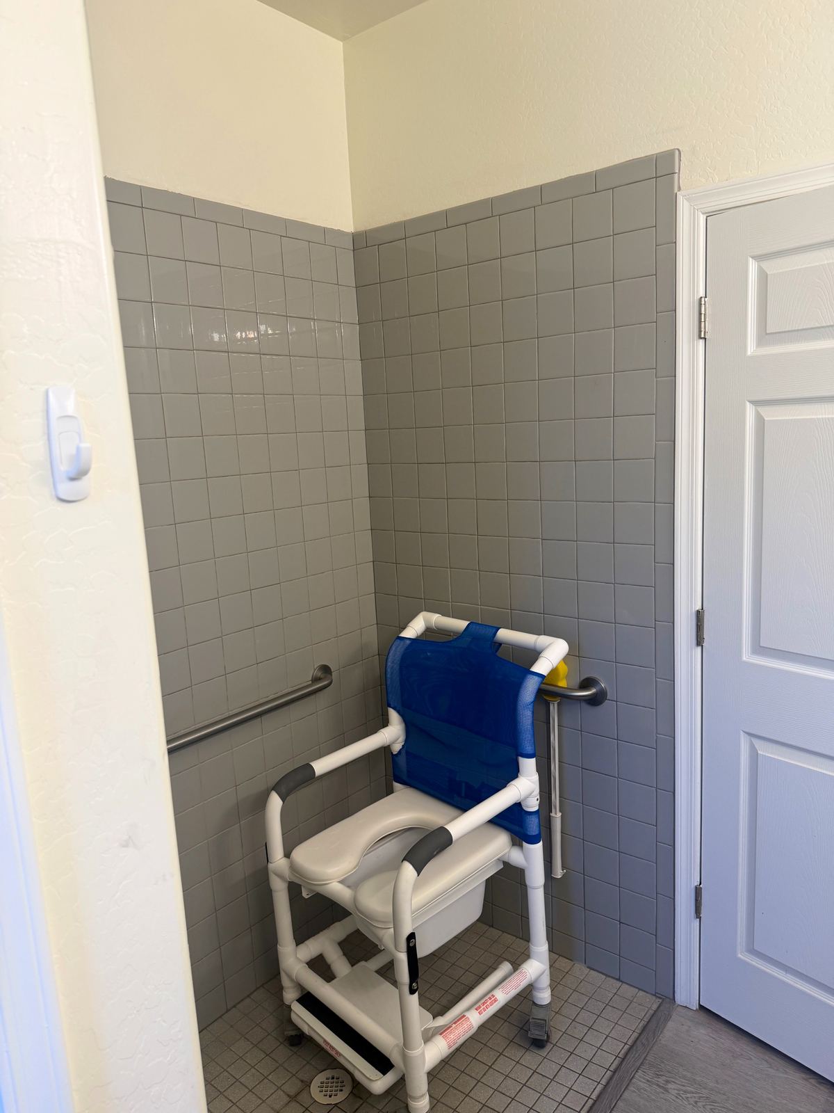 Accessible bathroom shower chair and tile wall