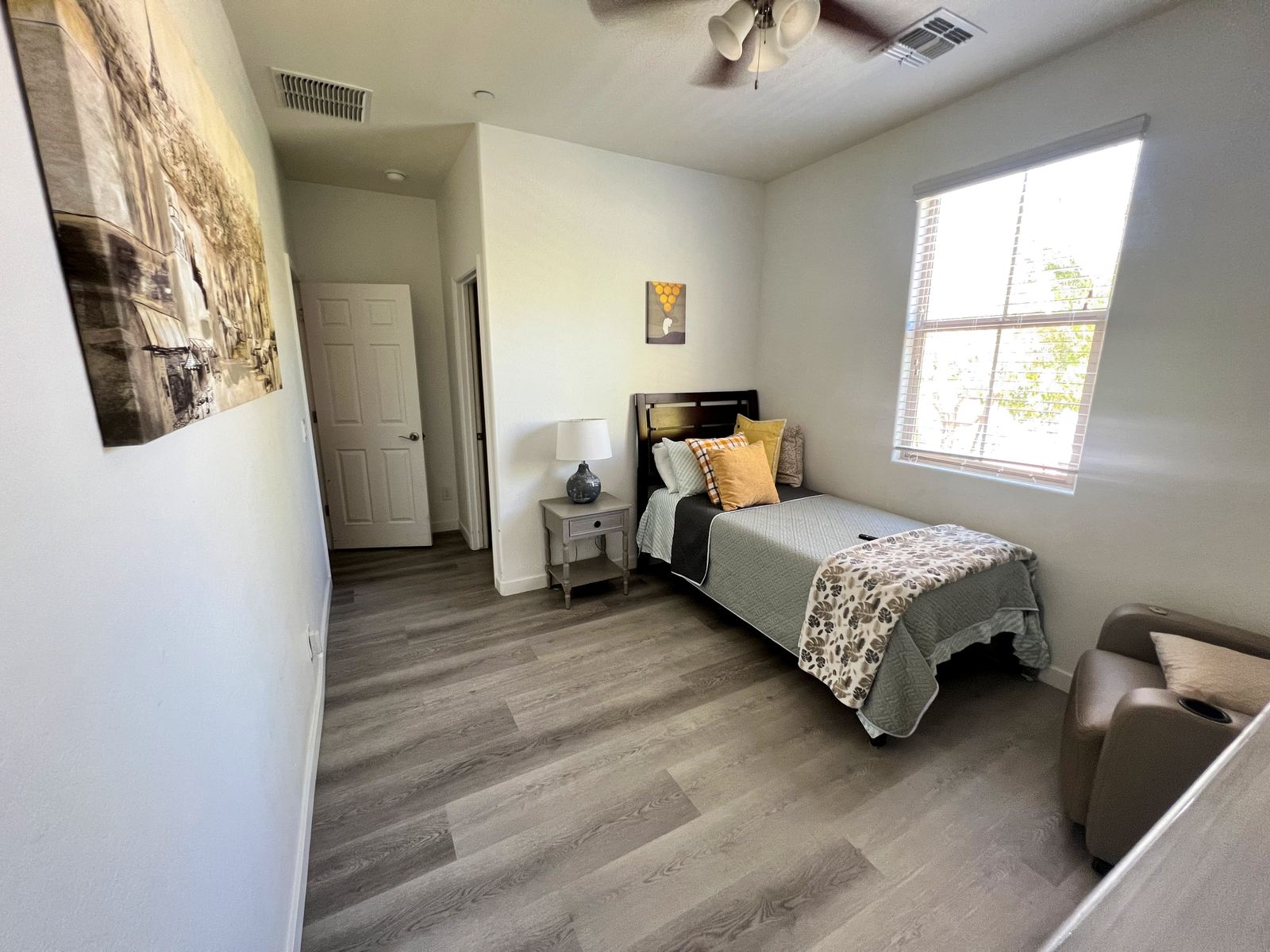 Private room at Sunnyside Assisted Living with bed, chair, and window