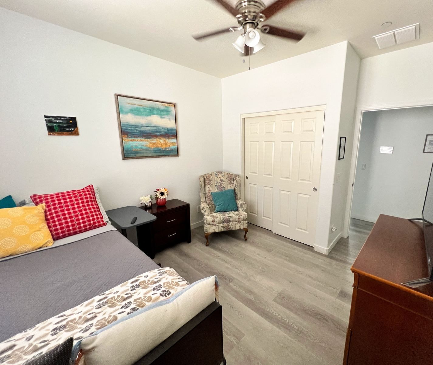 Shared resident room with bed, chair, and dresser