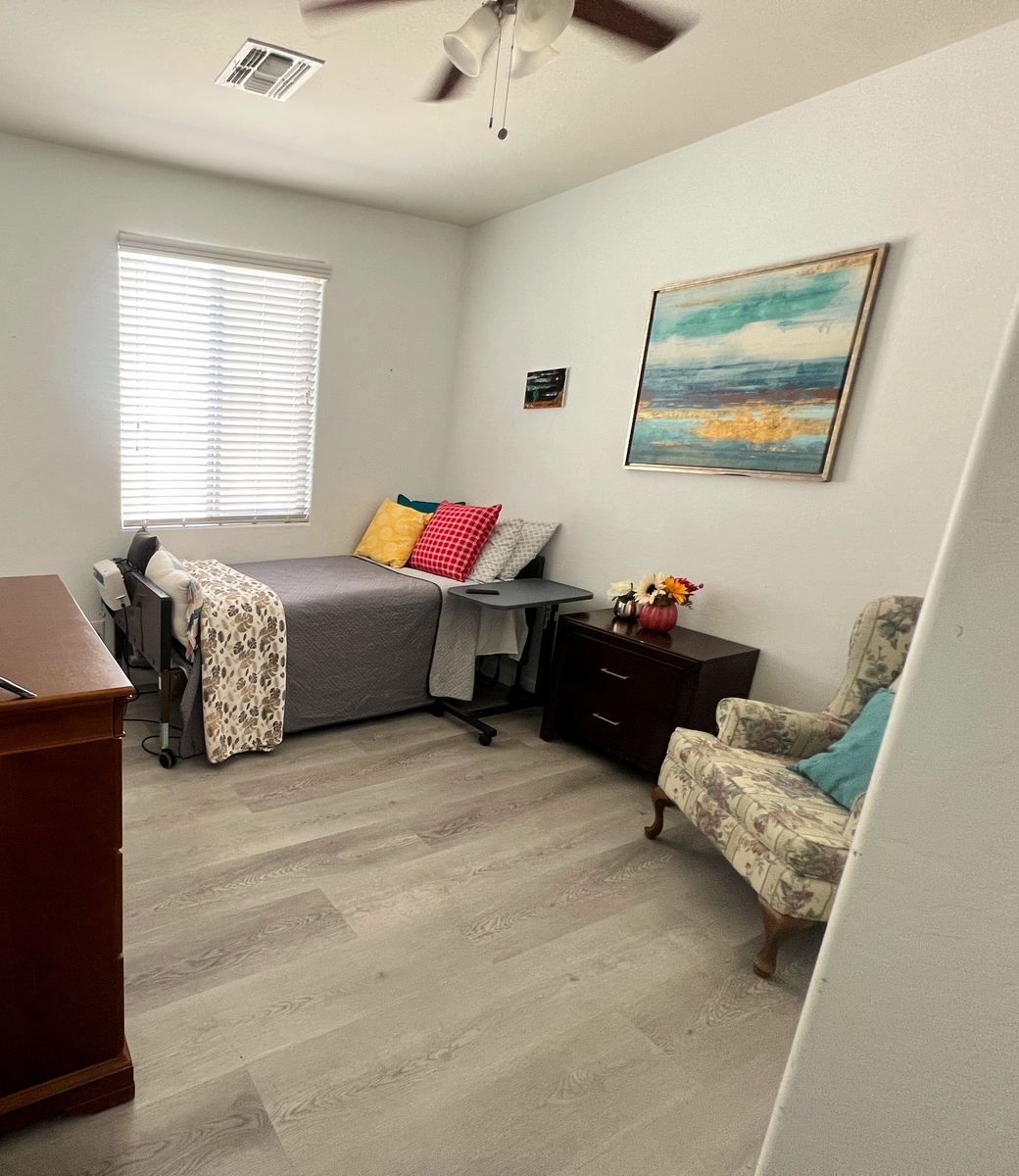 Resident room with bed, chair, and dresser